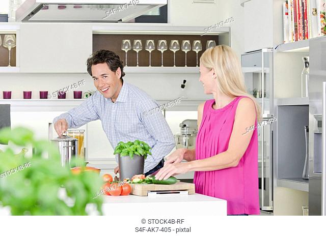 Couple preparing healthy meal in kitchen