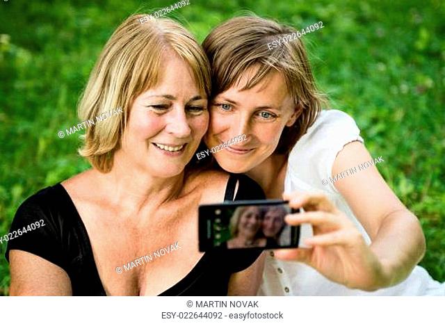Senior mother with child taking picture