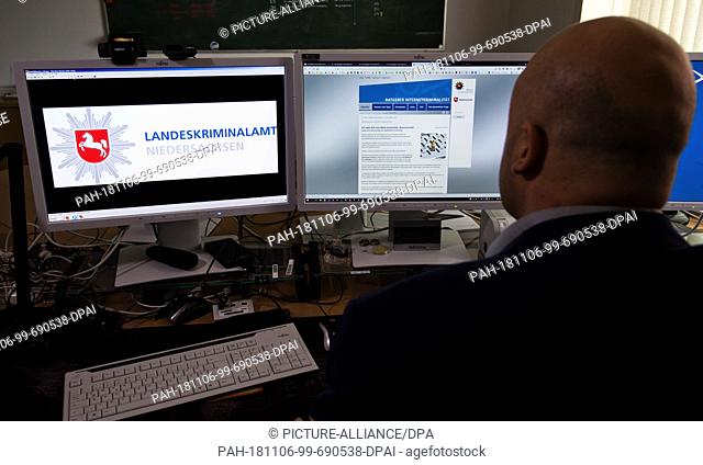 06 November 2018, Lower Saxony, Hannover: A police chief commissioner specialized in prevention in the area of Internet crime sits at his workplace in the State...