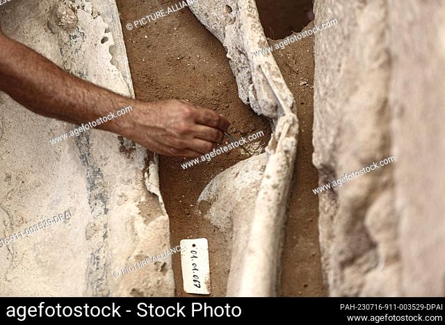 16 July 2023, Palestinian Territories, Beit Lahia: A member of a Palestinian excavation team working at a Roman-era cemetery in the northern Gaza Strip