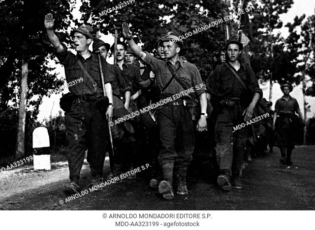 Soldiers of the Italian Alpine troops marching. The fourth regiment of the 'Littorio' Division marching and making the Roman salute