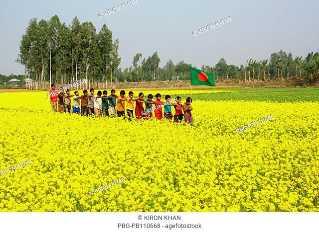 Children play at mustard flowers field at Dumur Sirajganj, Bangladesh December 2010