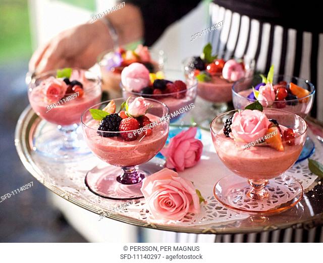 Summery raspberry mousse with roses and a berry garnish