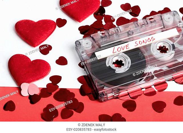 Audio cassette tape on red backgound with fabric heart