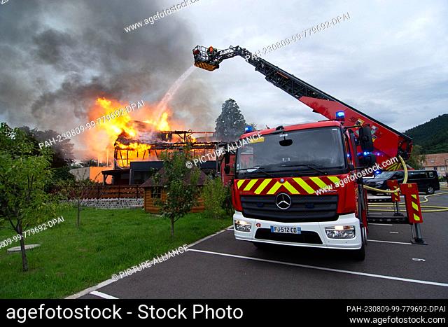 09 August 2023, France, Wintzenheim: Firefighters extinguish a fire in a vacation accommodation. Eleven people were missing after the fire