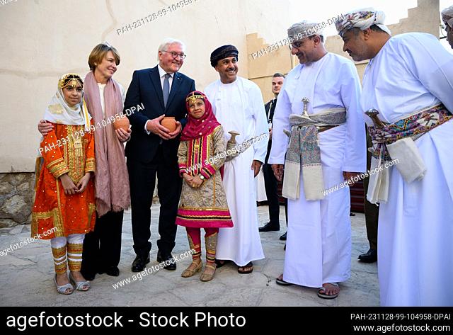 28 November 2023, Oman, Nizwa: Federal President Frank-Walter Steinmeier (3rd from left) and his wife Elke Büdenbender (2nd from left) are presented with gifts...