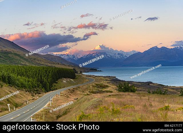 View of Mount Cook with road and lake, sunset, Lake Pukaki, Mount Cook National Park, Southern Alps, Canterbury, South Island, New Zealand, Oceania