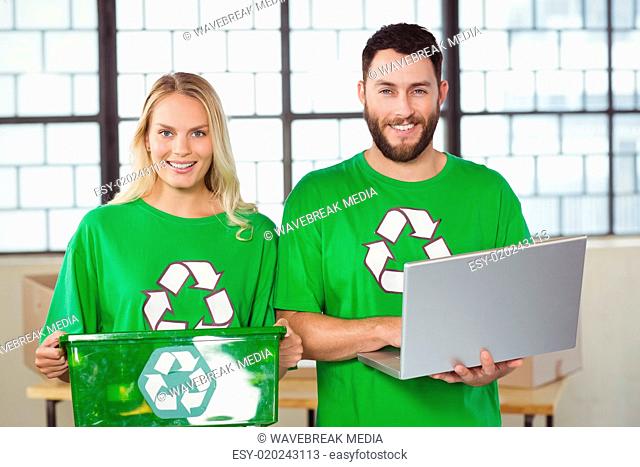 Portrait of smiling volunteers in recycling symbol tshirts