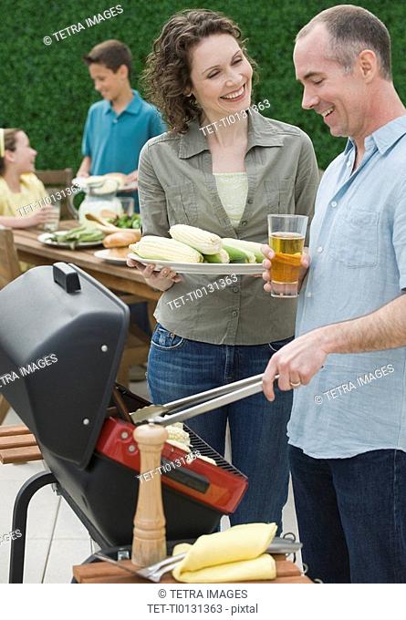 Family with two children barbecuing