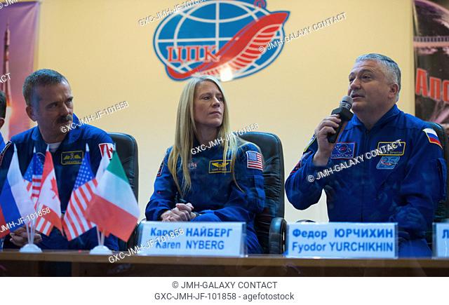 Russian backup crew member Fyodor Yurchikhin, right, answers a reporter's question at a press conference held at the Cosmonaut Hotel on Dec