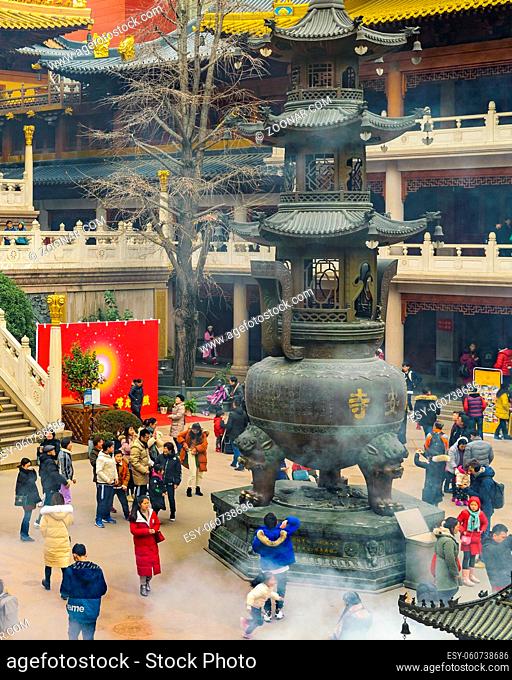 SHANGHAI, CHINA, JANUARY - 2019 - Crowd at jingan buddhist temple courtyard in shanghai city, china