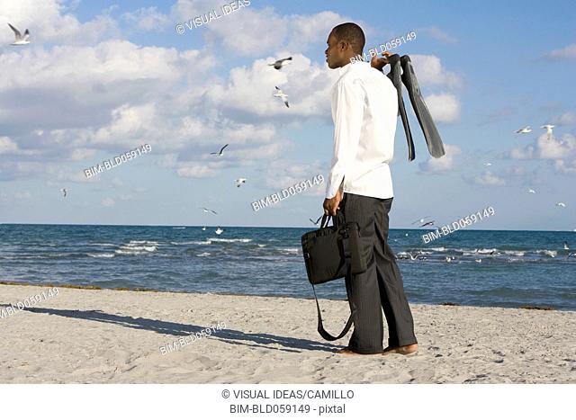 African businessman standing on beach