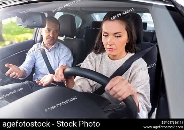 car driving school instructor teaching woman