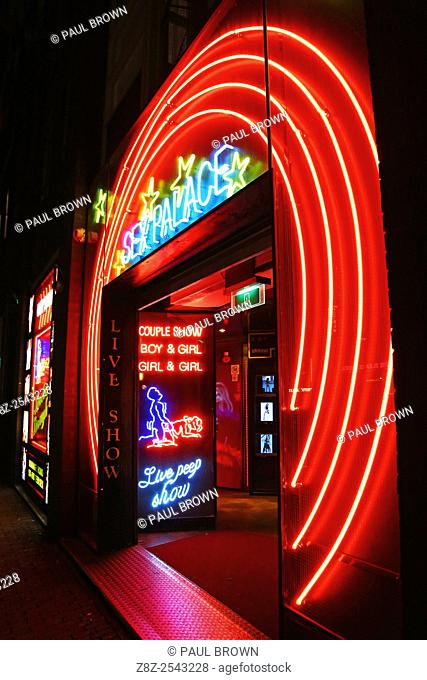 Neon lights of the Sex Palace porn shop and sex show theatre in the Red Light District famous for prostitutes and prostitution in Amsterdam, Holland