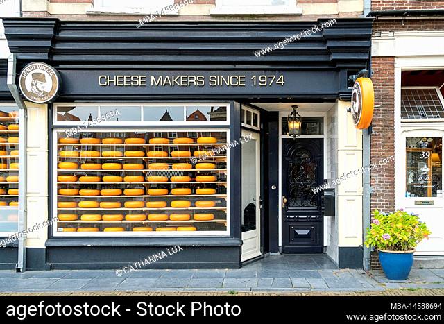 Delft (Netherlands), big market place, cheese store, window with cheese wheels