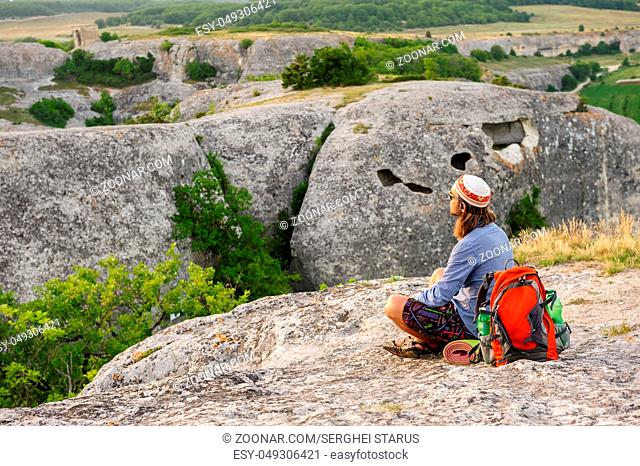 Hiking man having rest at the top of Eski Kermen, Crimea, Ukraine