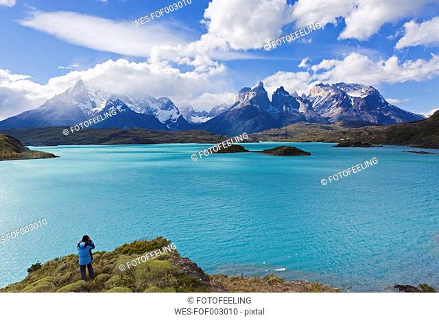 South America, Chile, Patagonia, Female photographer capturing an image ot torres del paine mountains