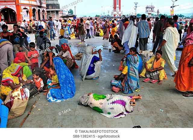 Pilgrims resting at Har Ki Pairi ghat by the Ganges river