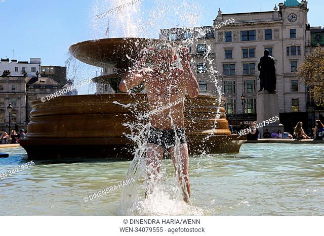 People having fun in the fountain in Trafalgar Square as hot weather continues. The temperatures in the capital likely to reach 28 degree celsius - hottest...