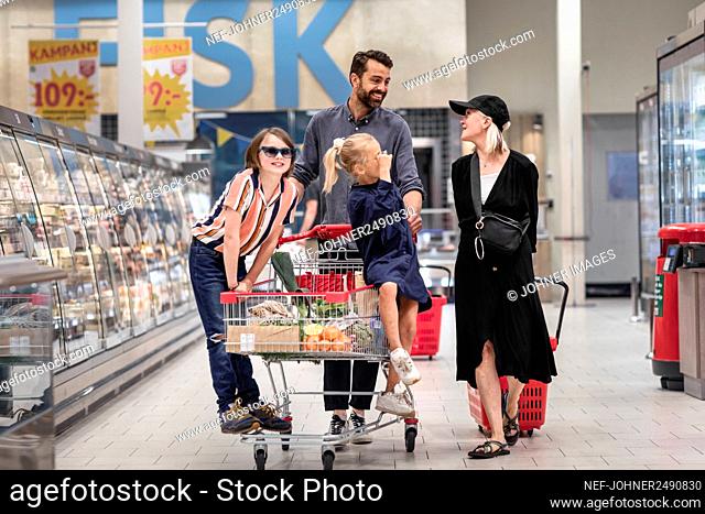 Father with daughters in supermarket