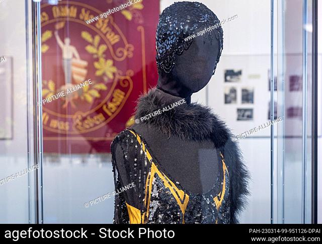 14 March 2023, Mecklenburg-Western Pomerania, Wismar: A hanging dress with dazzling sequins, beads and fringes can be seen in the special exhibition ""Golden...