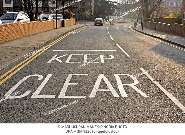 Keep Clear painted on the road Harrow ; London ; U.K. United Kingdom England