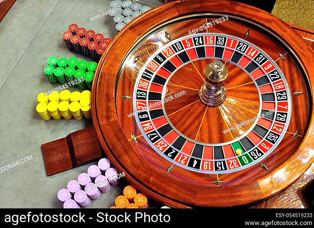 image with a casino roulette wheel with the ball on number zero