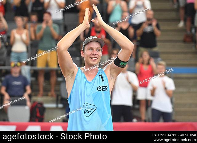14 August 2022, Hamburg: Beach Volleyball, Beach Pro Tour, August 14, 2022, Stadium am Hamburger Rothenbaum, Nils Ehlers of ETV Hamburg is happy about winning...