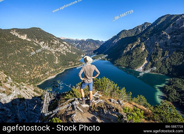 Hiker looks into the distance, behind Schönjöchl, Plansee, Ammergau Alps, Reutte district, Tyrol, Austria, Europe