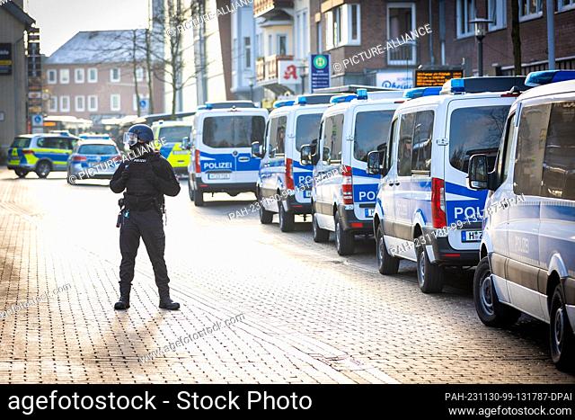 30 November 2023, Lower Saxony, Lehrte: Police vehicles are parked in front of a job center near the train station. The police have arrested a suspect who is...