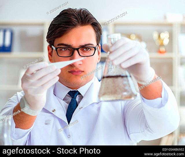 Young researcher scientist doing a water test contamination experiment in the laboratory