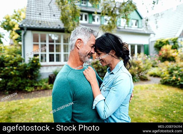 Romantic couple standing in backyard