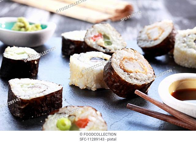 Various maki sushi with soy sauce and wasabi