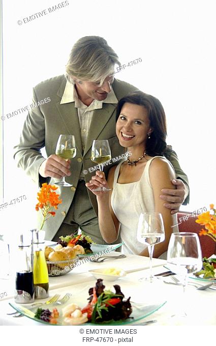 Couple at a set table with wine glasses