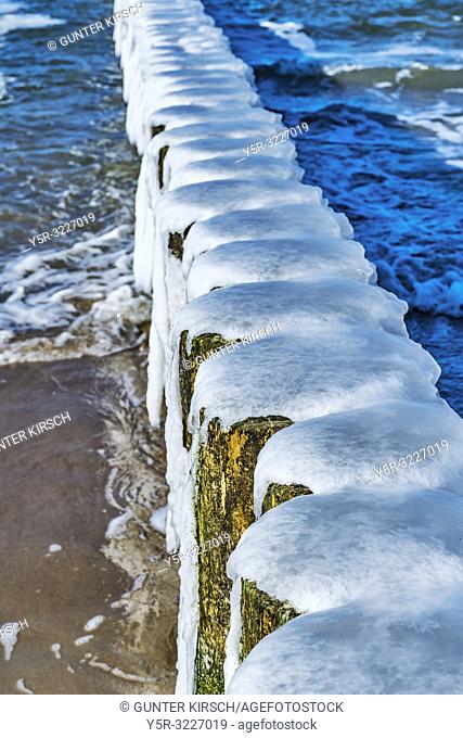 Ice covered Groynes at the beach of the Baltic Sea near Kolobrzeg. Groynes are intended to break the shaft and to prevent the erosion of the coast