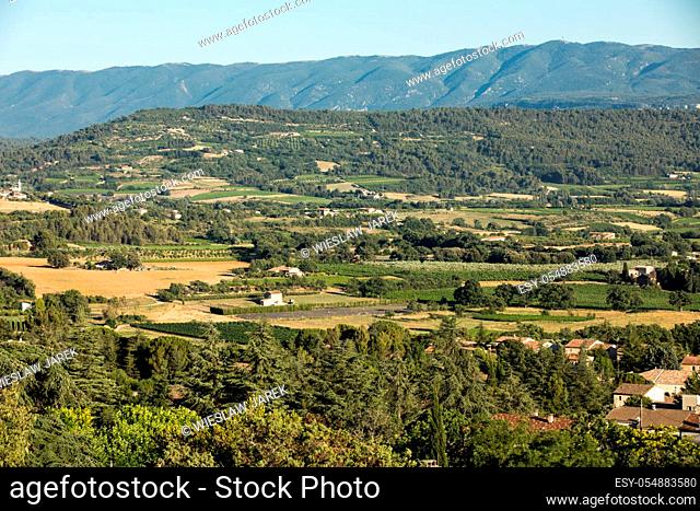 Panoramic view of cultivated fields, vineyards and mountains in Provence, France