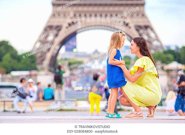 Happy mother and little adorable girl traveling in Paris near Eiffel Tower