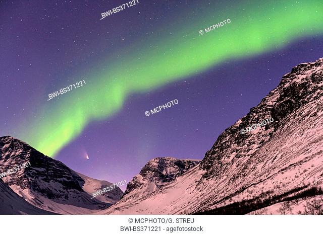 comet Pan-STARRS and Aurora borealis over mountains in Vistasdalen in moonlight, Sweden, Lapland, Kebnekaisefjaell