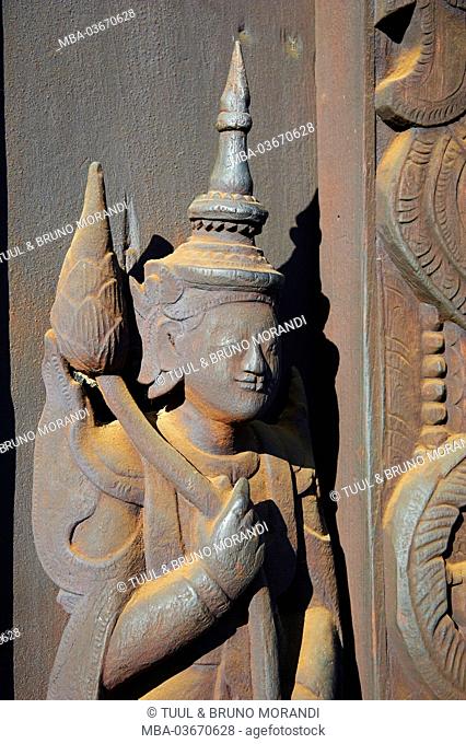 Carved character in the Kyaung Shwe In Bin monastery, Myanmar, Asia