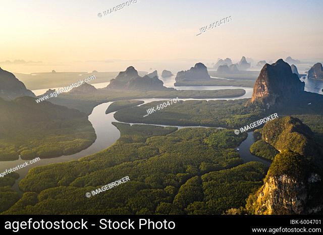 Aerial view, mangrove forest with meandering river and high karst rocks during sunrise, Ao Phang-Nga National Park, Phang-Nga Province, Thailand, Asia