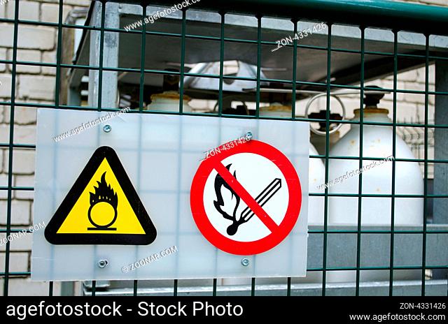 fire warning signs symbol near compressed oxygen gas cylinders. dangerous objects