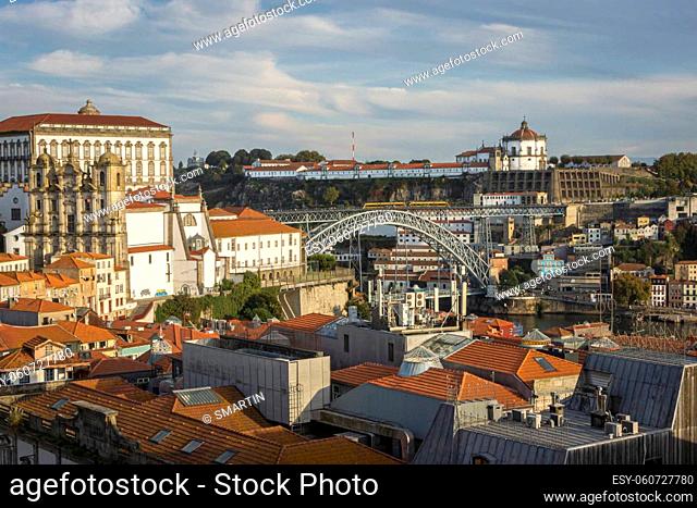 View of the city of Porto and Pont Luiz bridge, Portugal across ancient tiled rooftops