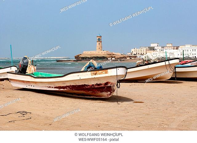 Fishing boats at the beach, Sur Lighthouse in the background, Sur, Oman