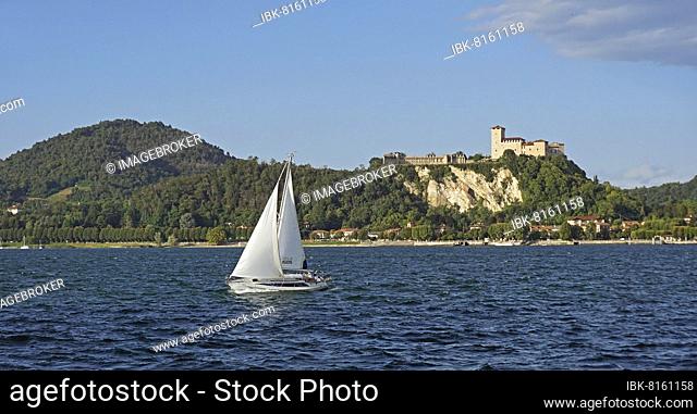 Sailing boat and castle of Angera or Rocca Borromeo di Angera, Angera, Lombardy, Italy, Europe