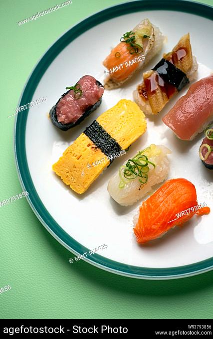 Sushi platter, a selection of raw fish and rice snacks with chopsticks