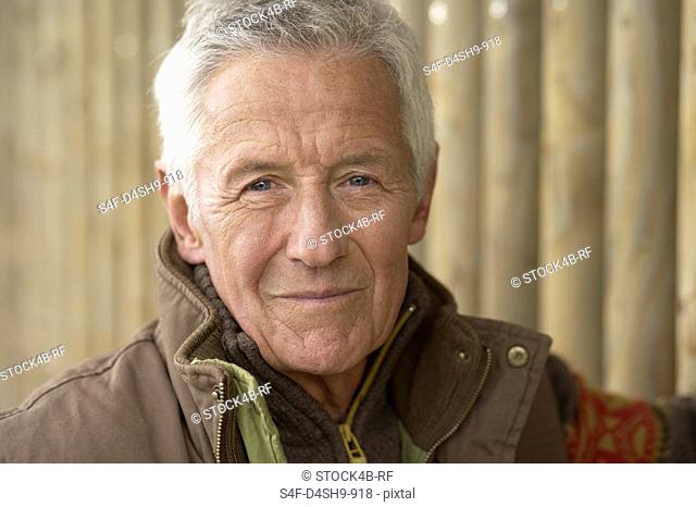 Senior adult man wearing an anorak, close-up