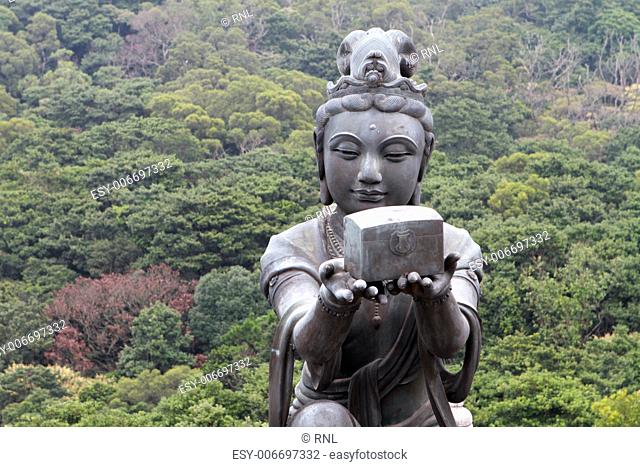 A Buddhistic statue making an offering to the Tian Tan Buddha in Hong Kong