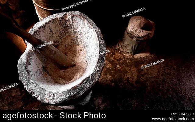 Ancient flour mortar. Wooden vessel for manual hand grinding. Authentic craft workshop. This method has been in use for many thousand years