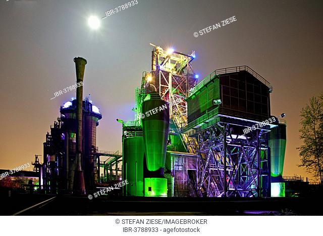 The disused steelworks in Landschaftspark Duisburg-Nord, public park on a former industrial site, illuminated at night during a full moon, Duisburg
