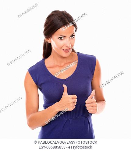 Cute hispanic woman standing with thumbs up while looking at you in white background